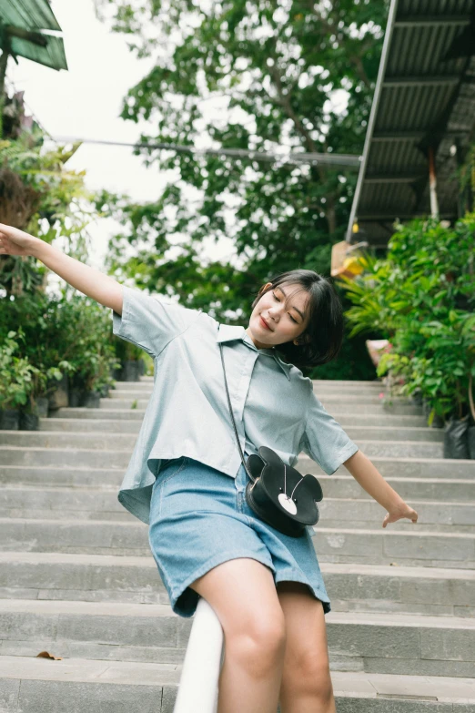 a smiling girl climbing up the steps, carrying a guitar