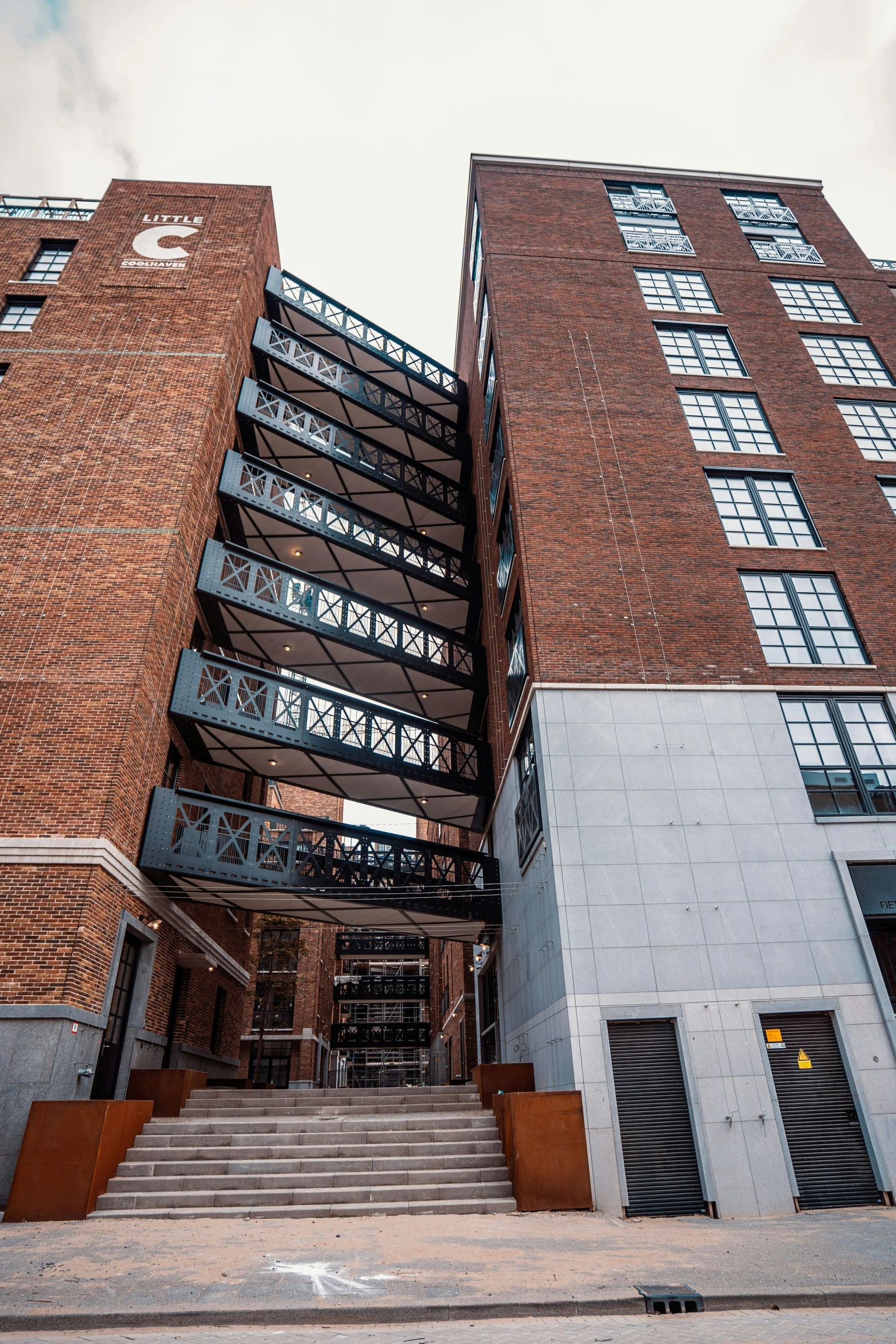 a building with many windows is shown under a cloudy sky