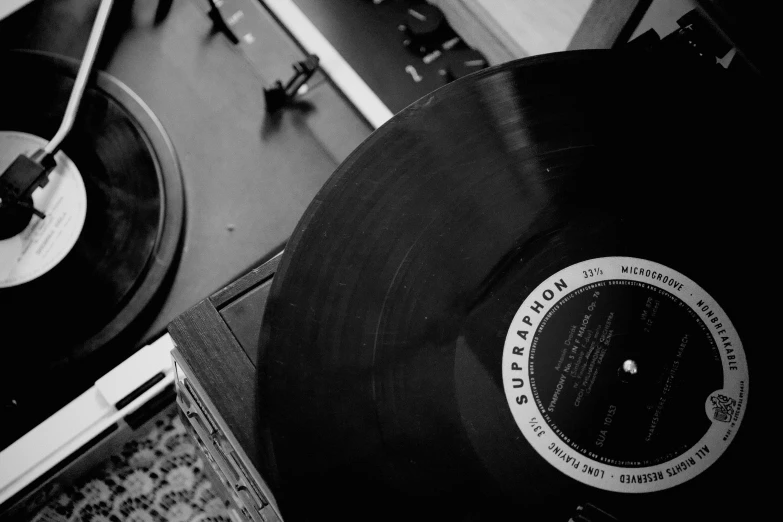 a pair of vinyl record players next to a stereo