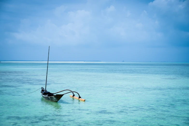 a lone boat out in a blue sea