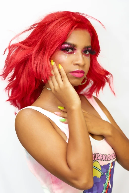 a close up of a woman wearing a pink shirt and green nails