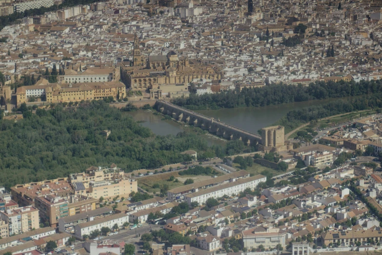 an aerial view of a city and bridge with some boats