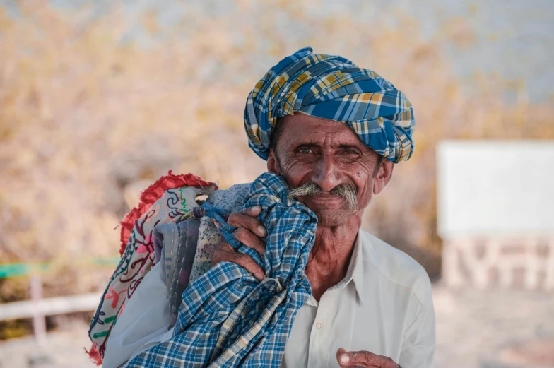 a man in a turban is posing for the camera