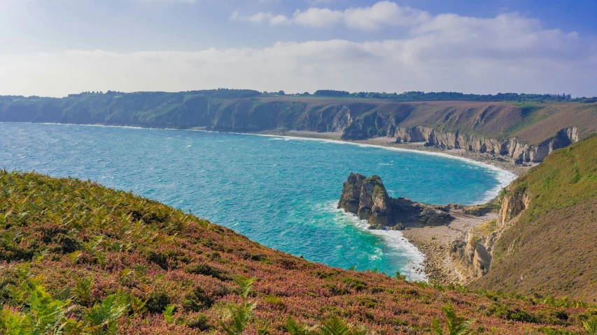 view of beach area near a cliff on the ocean