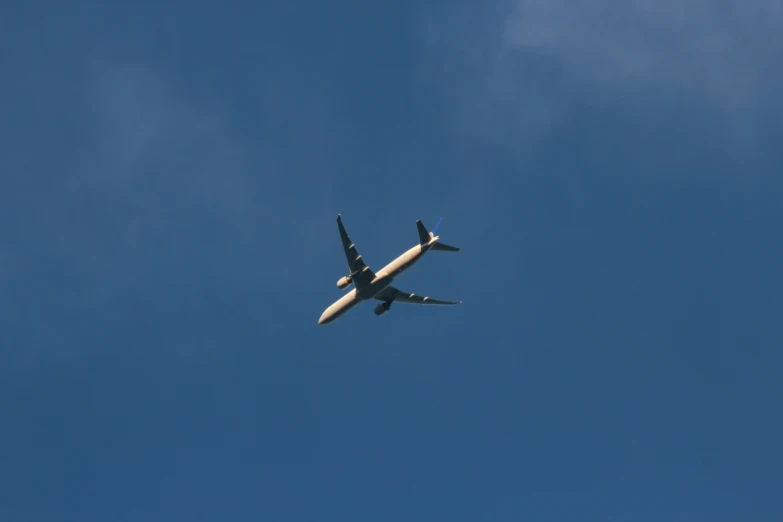 an airplane flying through the blue sky