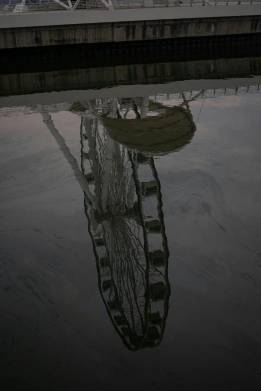 a boat is reflected in water next to a dock