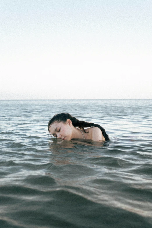 there is a girl that is submerged in the water
