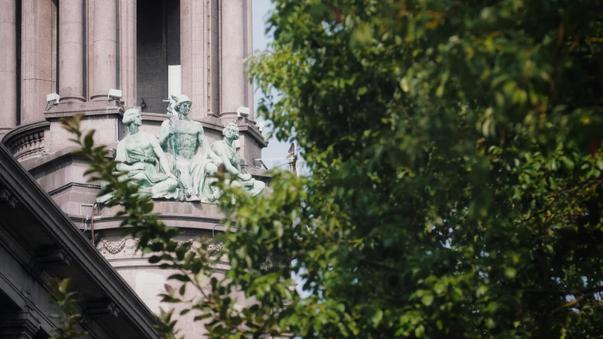 an image of a clock tower with statues on it