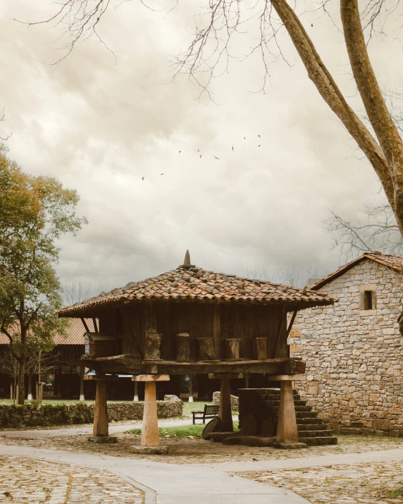 an old building stands near a tree in the background