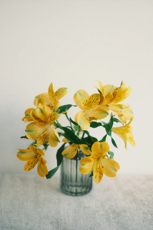 a little vase that is holding a bunch of flowers