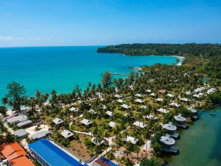an aerial view of a beautiful tropical resort by the sea