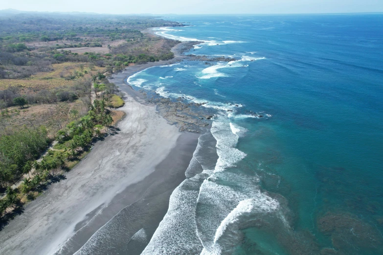 an aerial view of an ocean area and beach