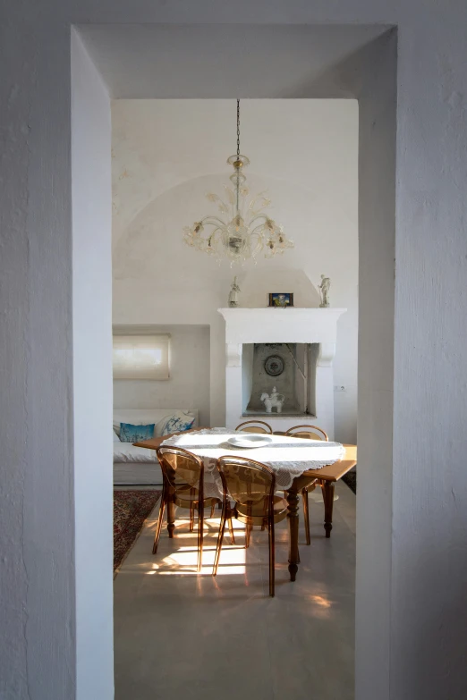 an open doorway into a dining room with a fireplace