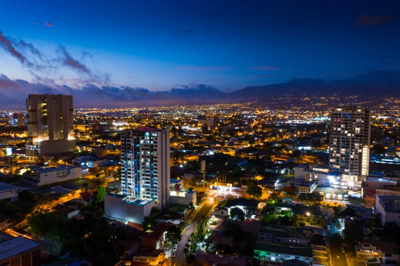 a nighttime scene of a cityscape with skyscrs and buildings lit up