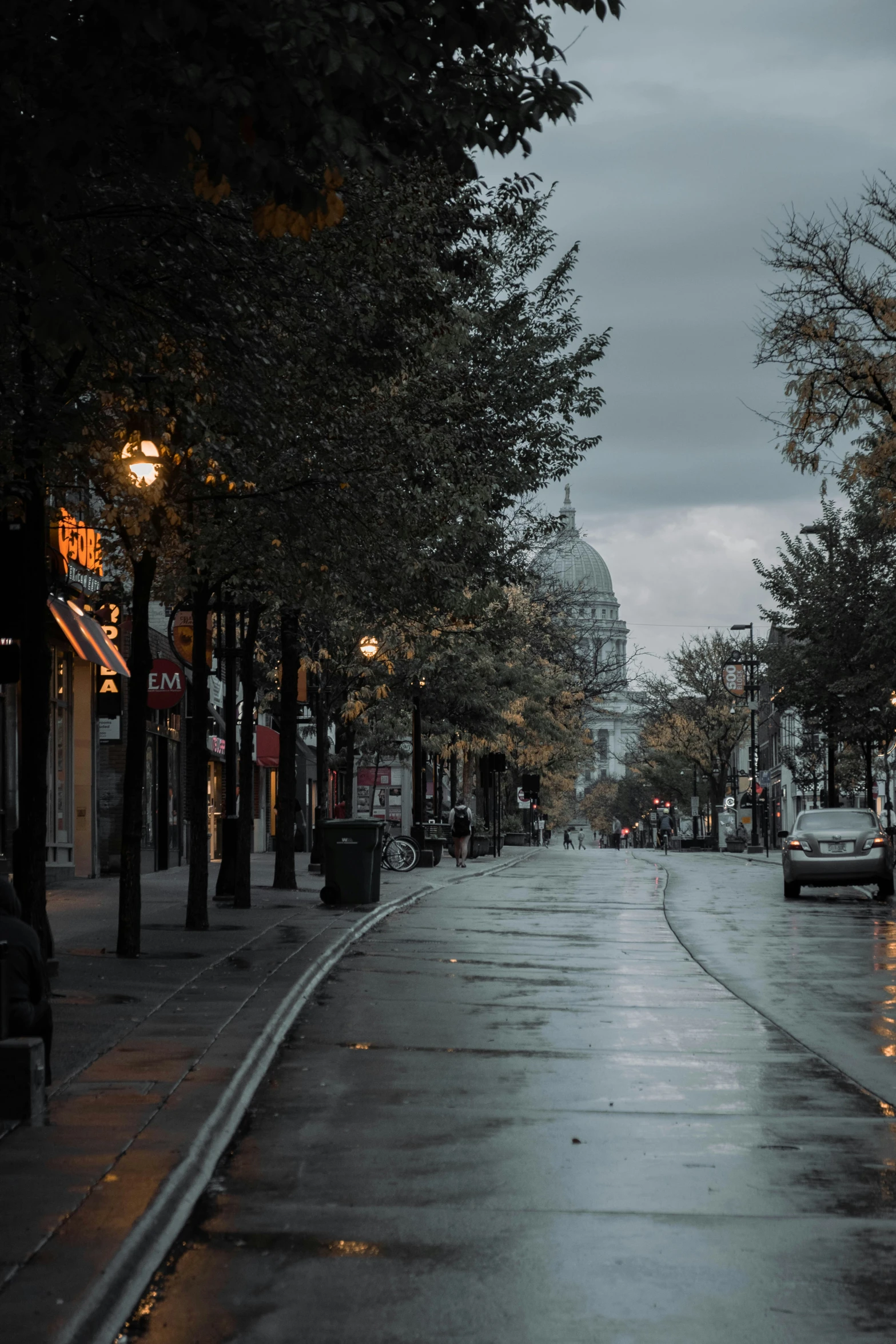 an empty city street with the sun set in