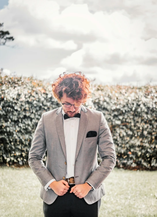 an image of a man with curly hair in a suit