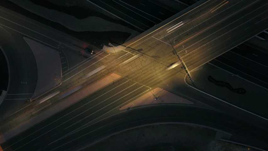 aerial po of an empty intersection with headlights