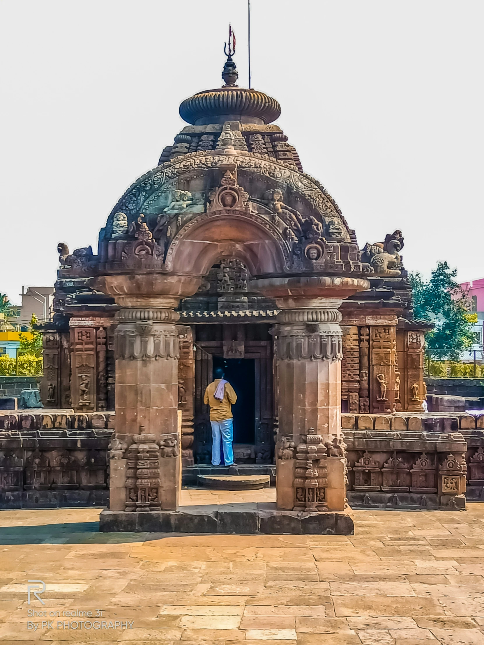 the man is in the doorway of a large indian structure