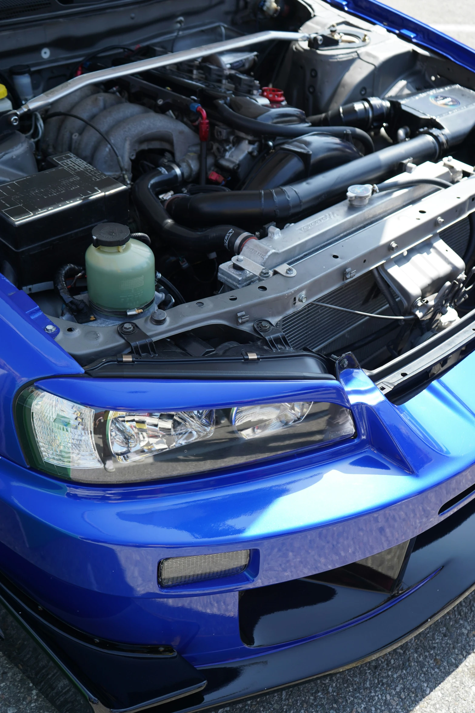 a blue sports car with the engine bay open