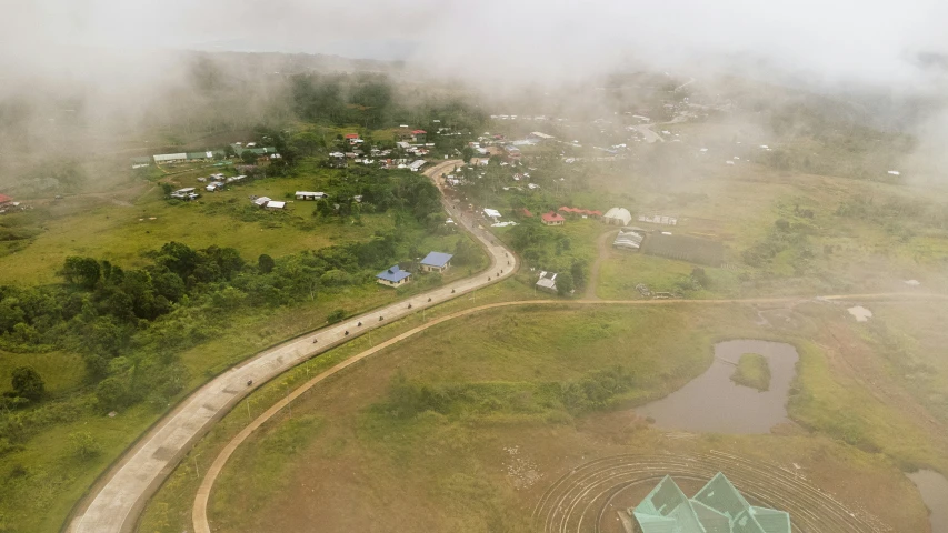 a small village surrounded by lush green grass