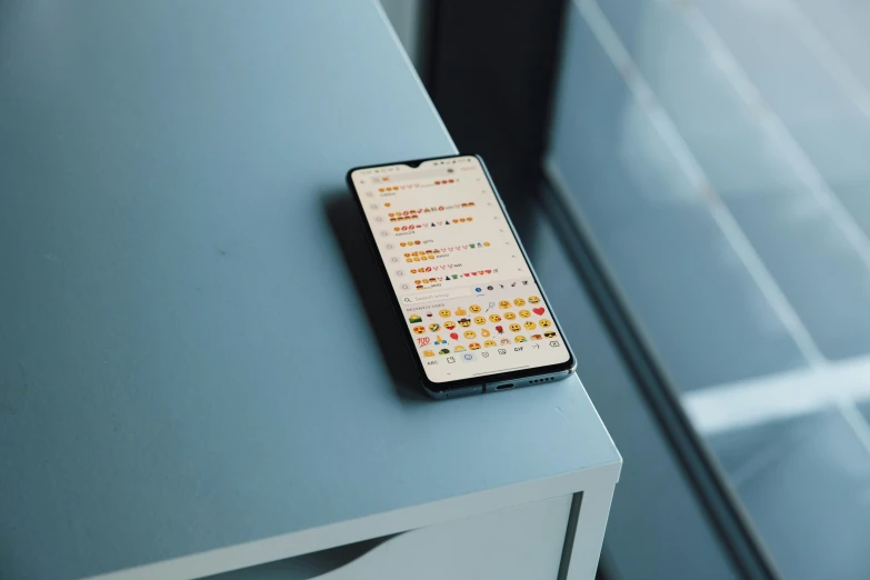 a smart phone laying on a side table