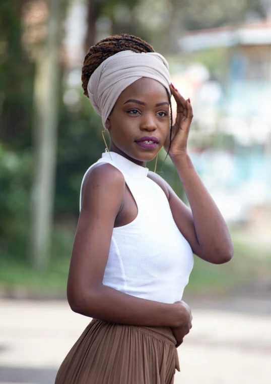 a woman standing on the street talking on her cell phone