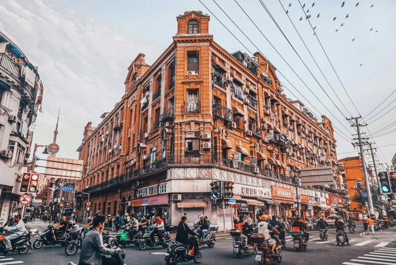 the city has many bikes, motorcycles and pedestrians in it