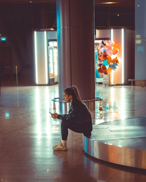 a woman sitting on top of a metal bench