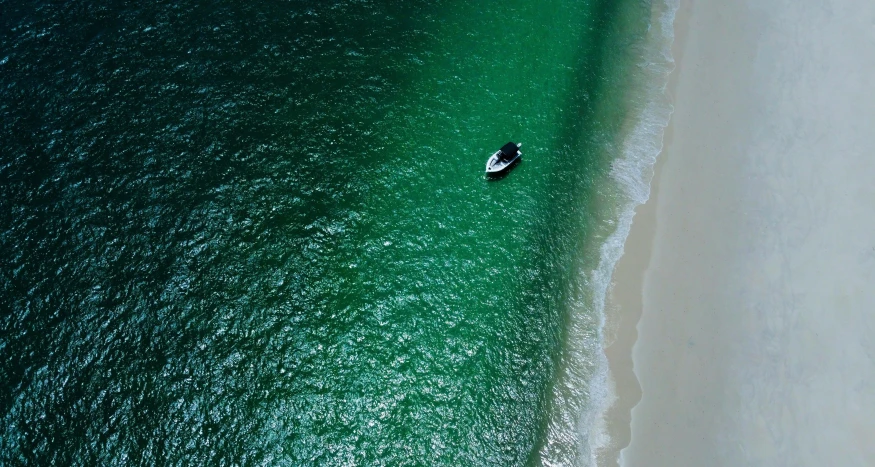 a boat floating in the middle of an ocean