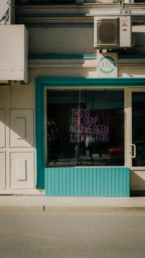 a window that has a sign that reads the store is open