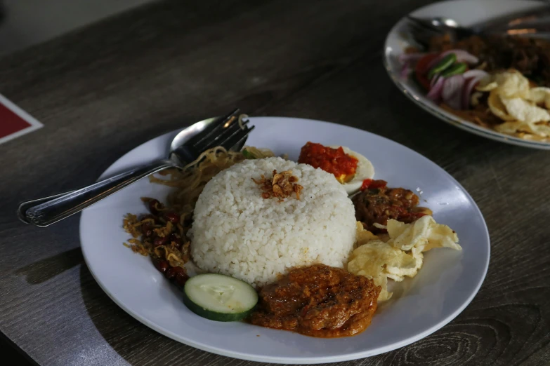 some food with rice, bread and a vegetable