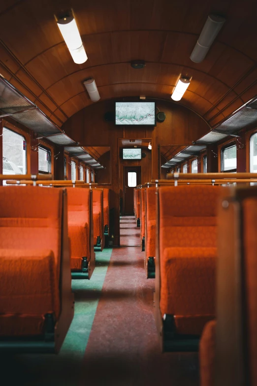 there is empty red and green seats in the train