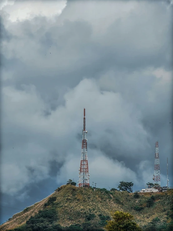 some clouds and two towers on a hill