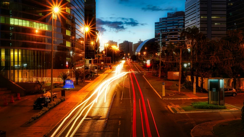 car lights shining down the street in a city