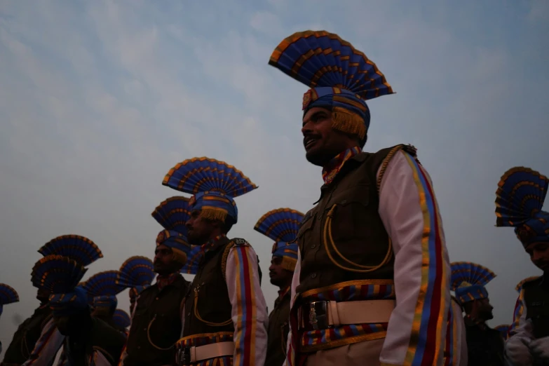 an indian band member in blue, orange and red uniforms