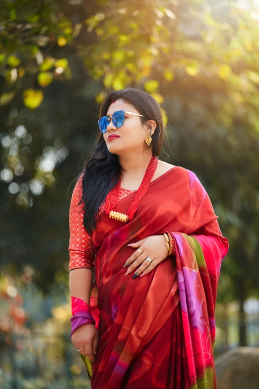 a woman in a saree holding her belly