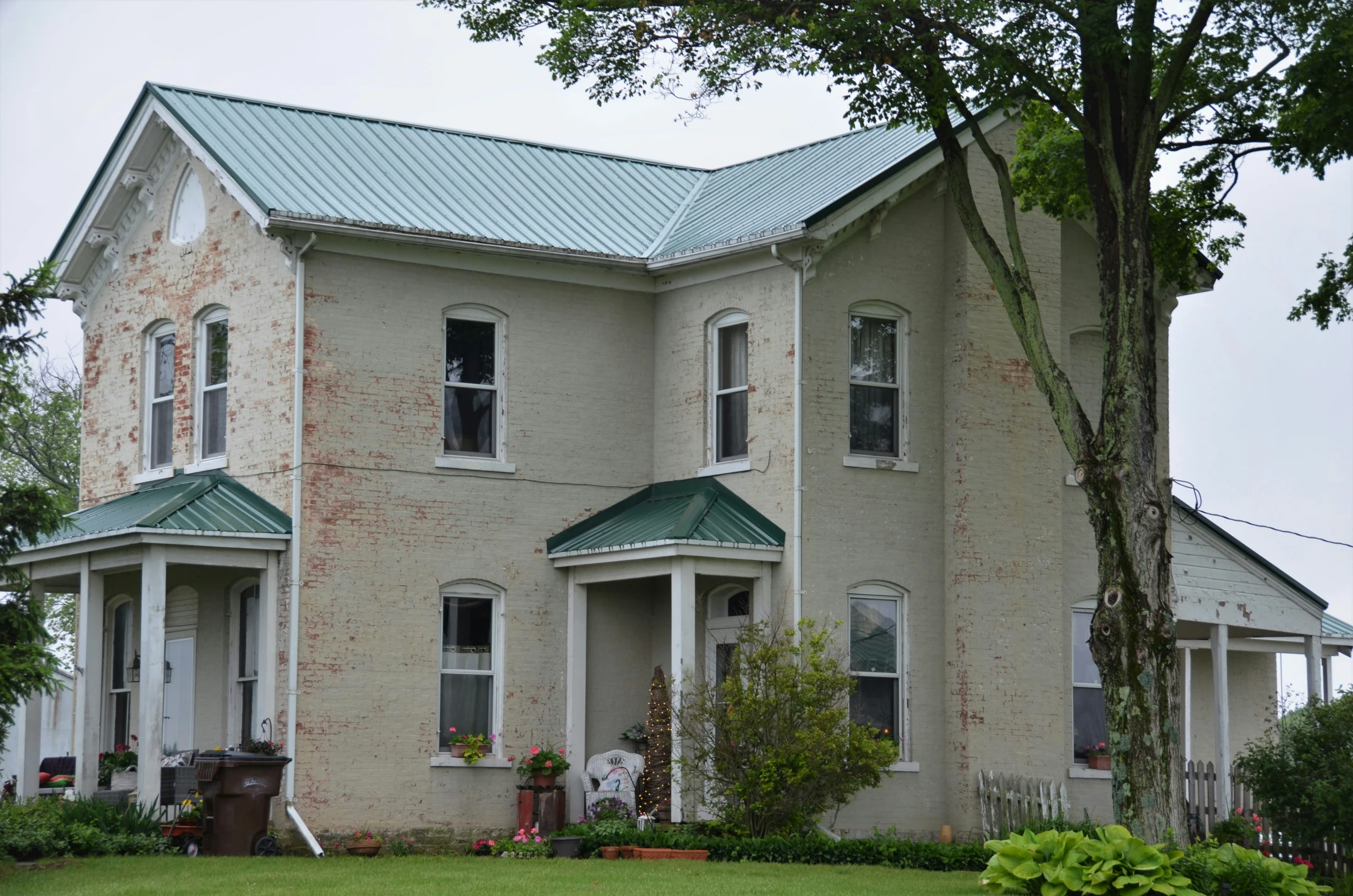 a large house with green roof and windows