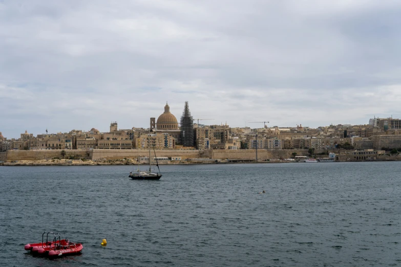 a boat floating on the water near the city