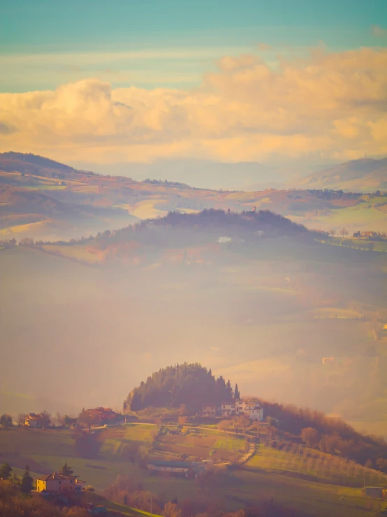 landscape with a foggy mountain range in the background