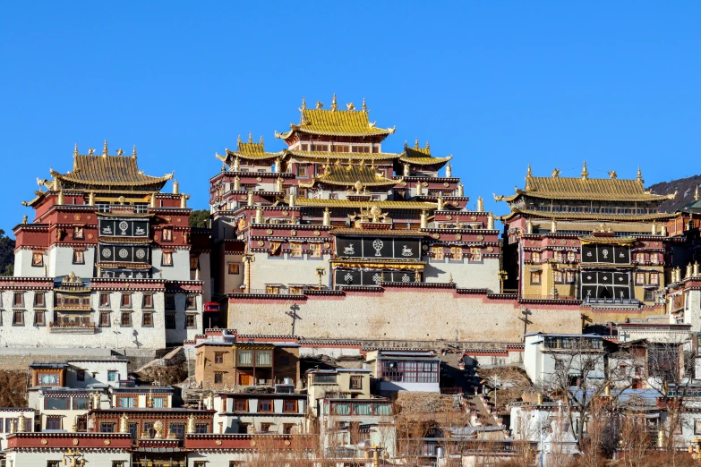 a city with tall buildings next to a hill