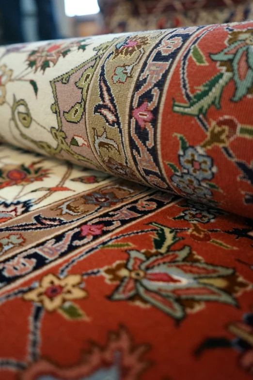 many colorful carpets with designs on them and the floor