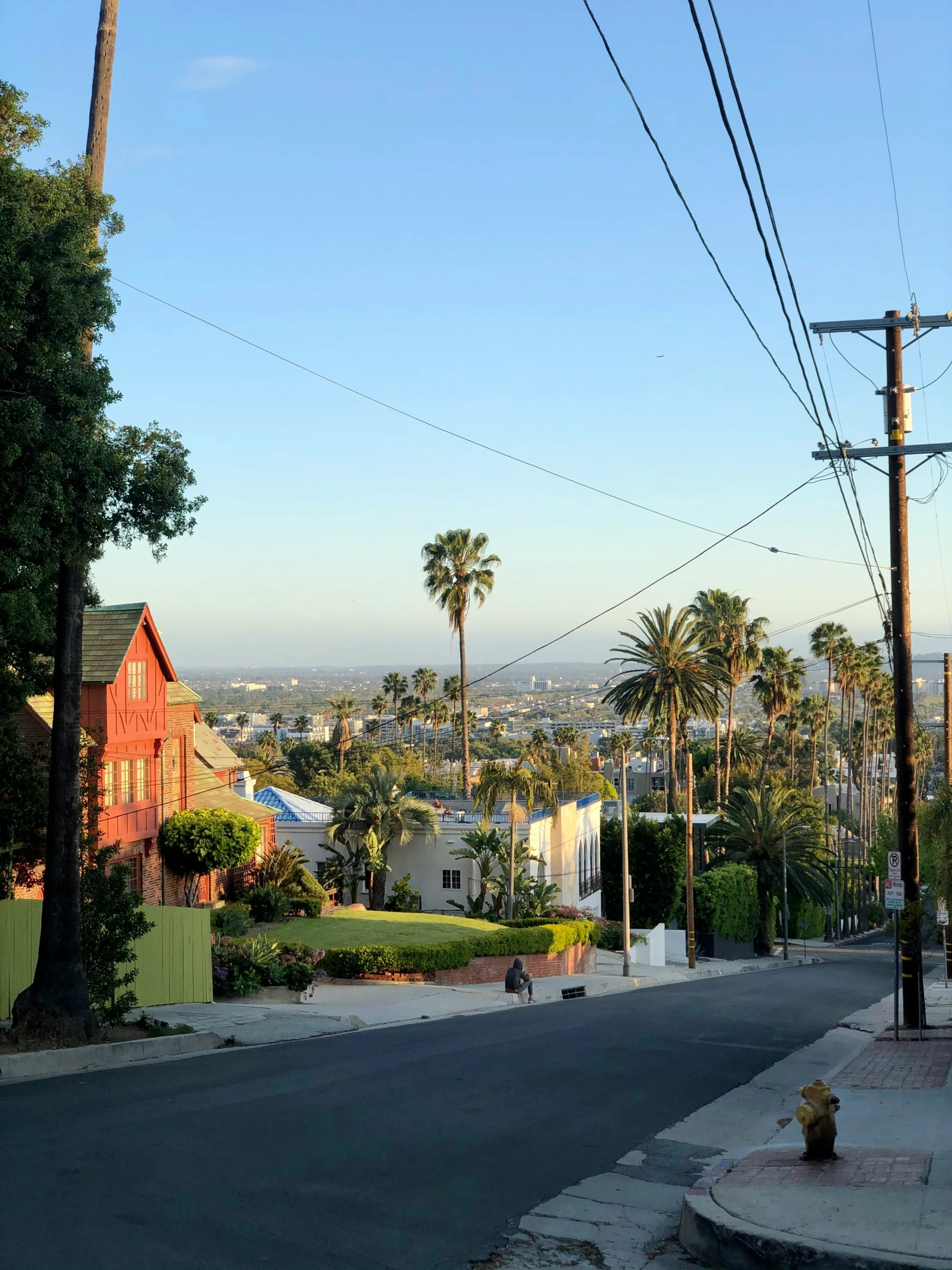 an empty street with a telephone pole above it