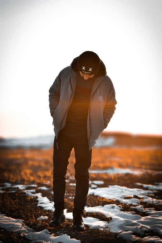 the man is standing alone on the snow covered ground