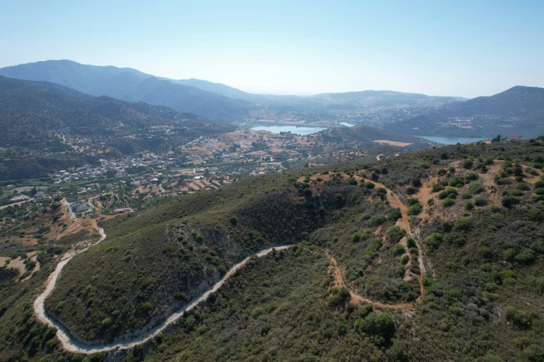 the road cuts through the land to reach a city