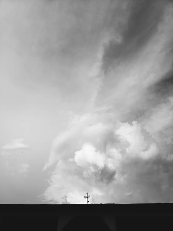 black and white po of a building under a cloudy sky