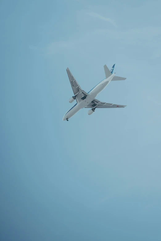 an air plane is flying through a blue sky