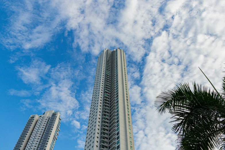 tall buildings sitting under a cloudy blue sky