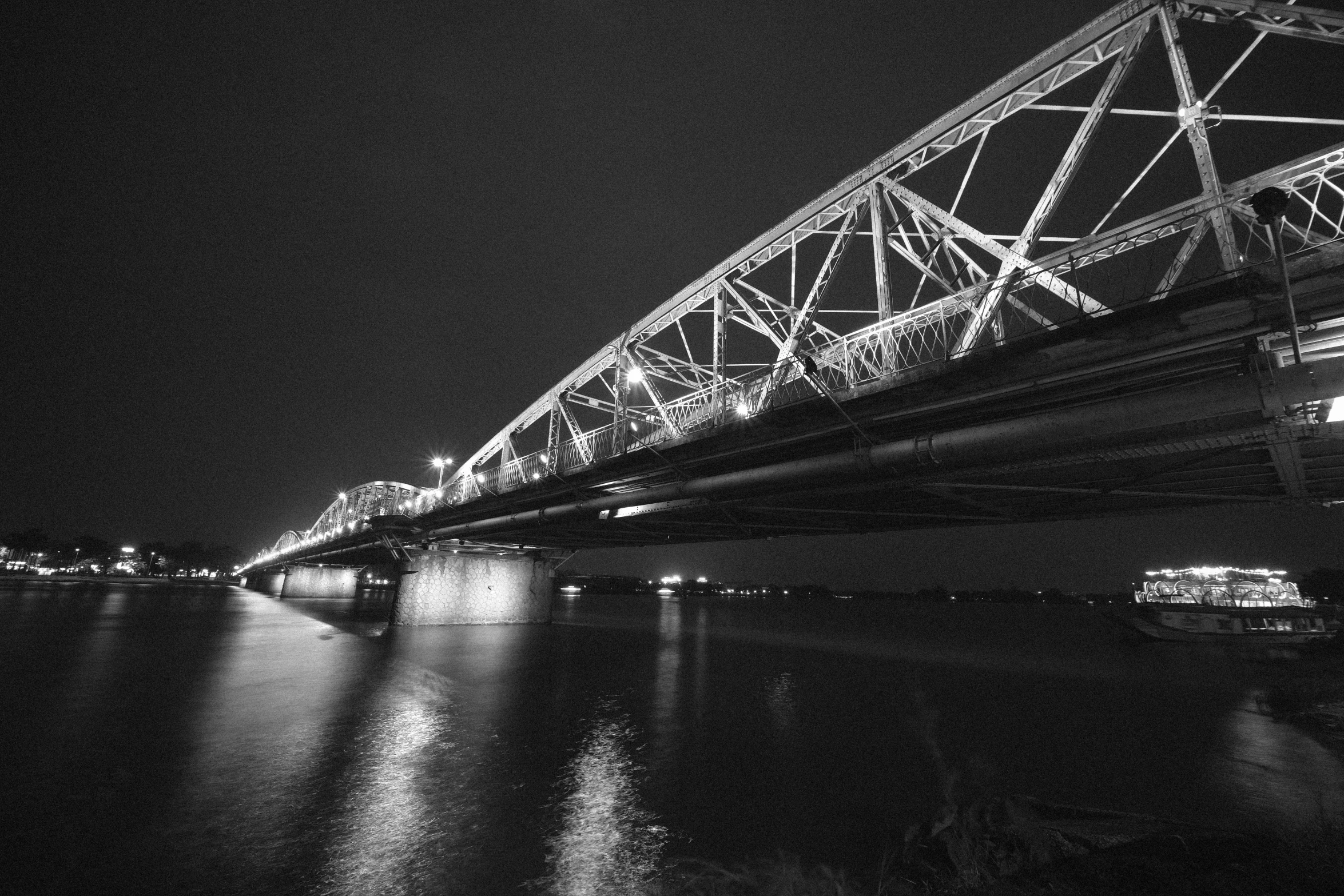 a large bridge that is on the side of the water