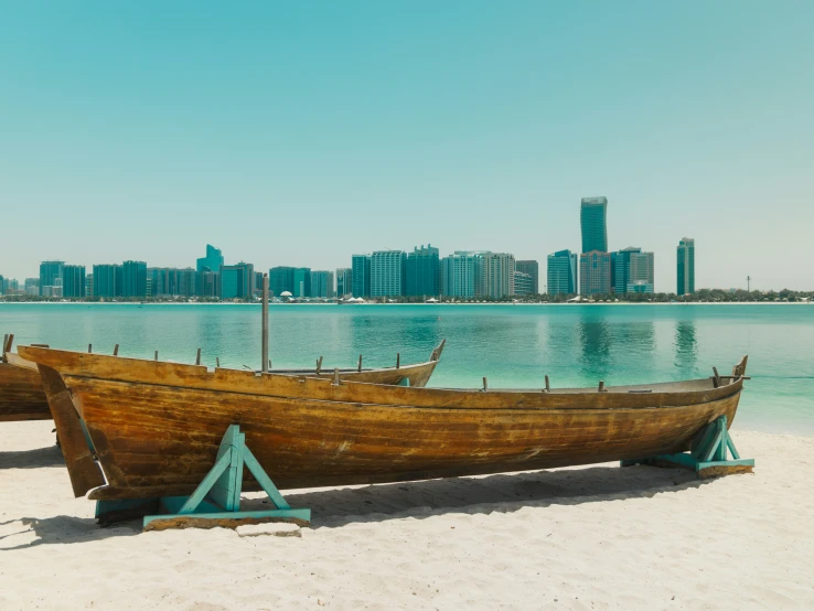 a boat on sand by a body of water