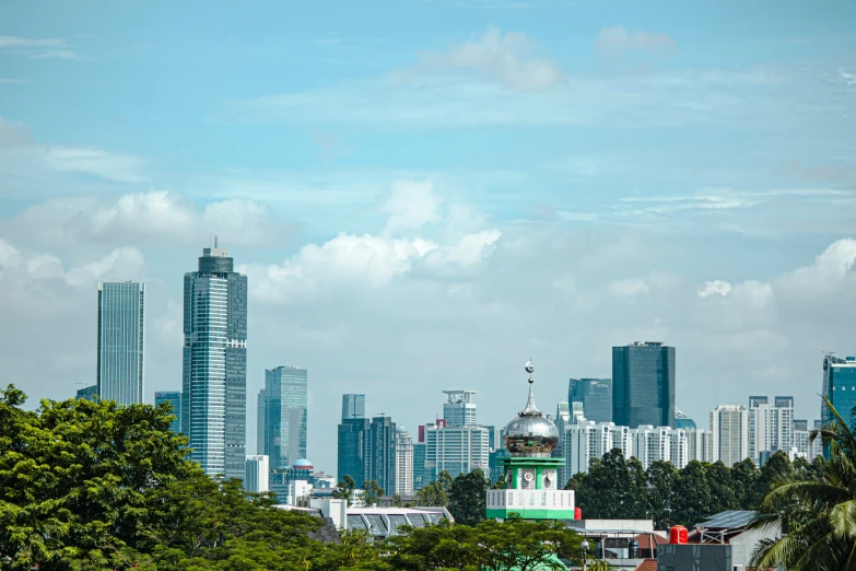 some buildings and trees in the background and a blue sky